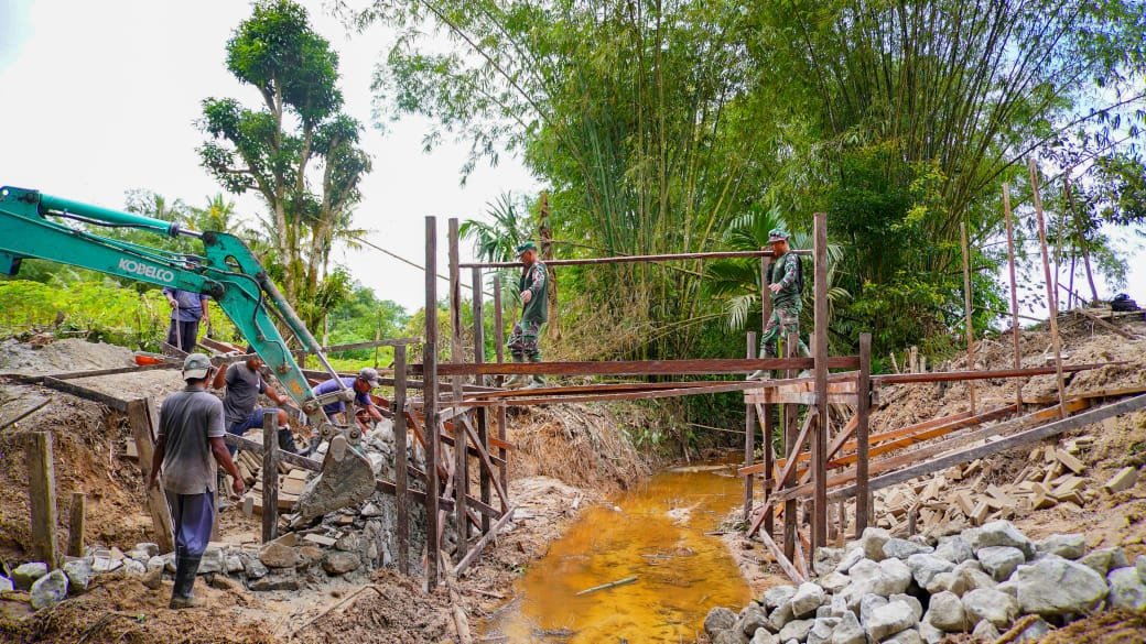 Saling Memberi Semangat, TNI dan Warga Percepat Pembangunan Pondasi Jembatan   